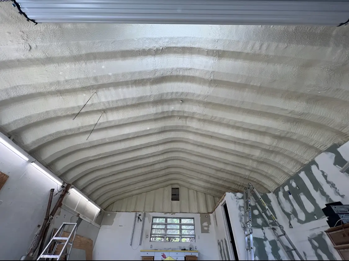 Spray polyurethane foam applied to the underside of a metal roof deck in Hammond